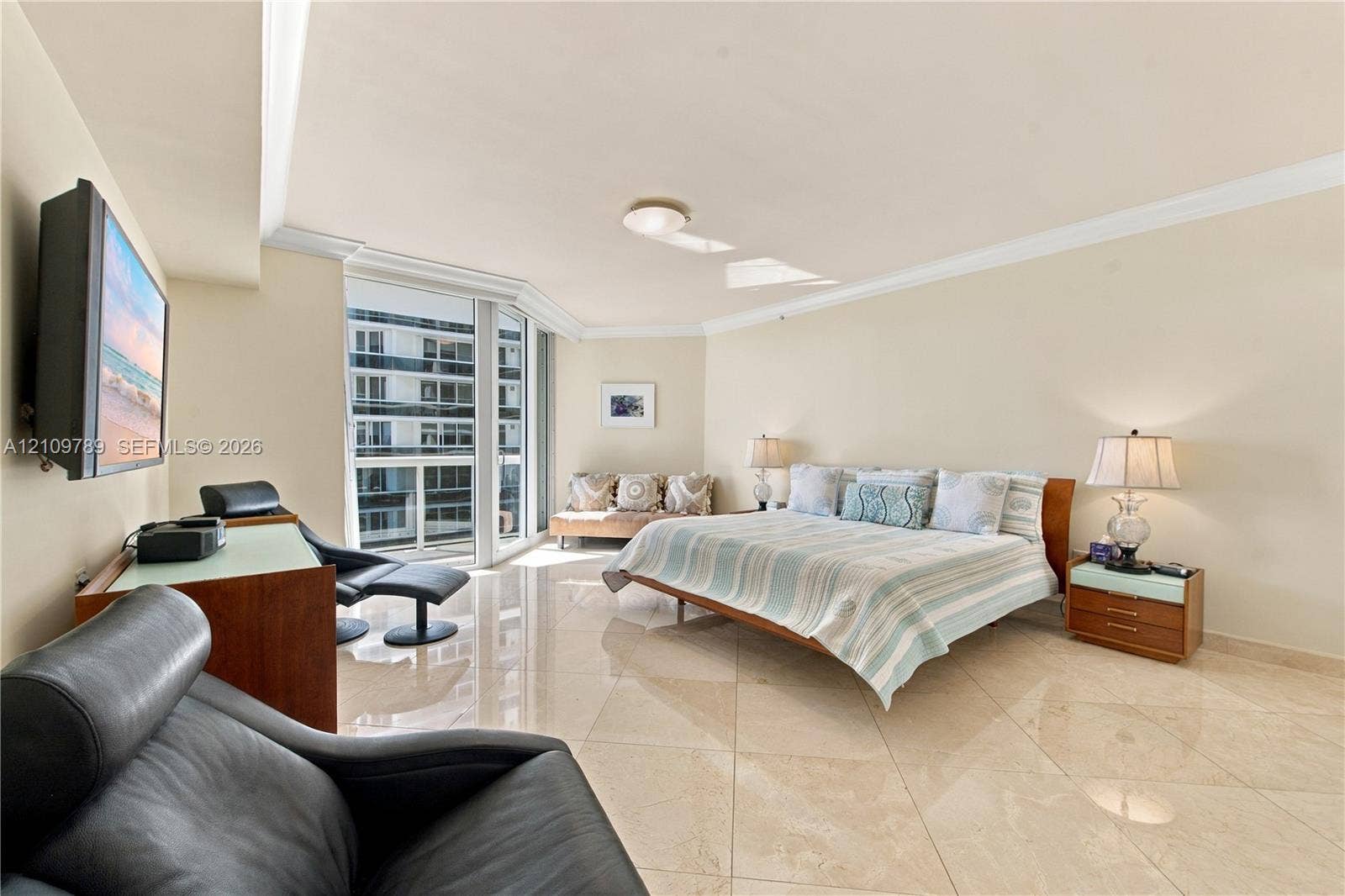9595 Collins Avenue, #N6-B, Surfside, Surfside, FL 33154 Polished stone flooring, crown molding, and floor-to-ceiling windows featuring a glass balcony enclosure