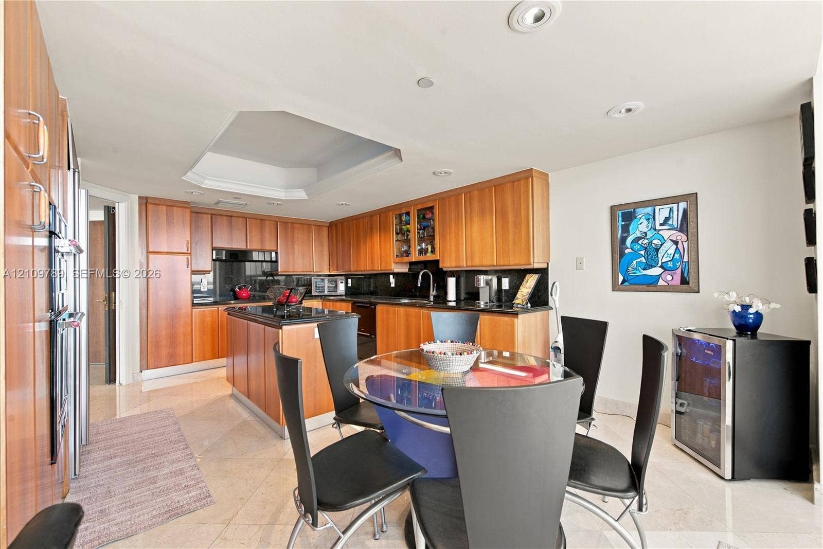 9595 Collins Avenue, #N6-B, Surfside, Surfside, FL 33154 Kitchen featuring wood-veneer cabinetry, stone countertops, central island, recessed ceiling lighting, and polished stone flooring