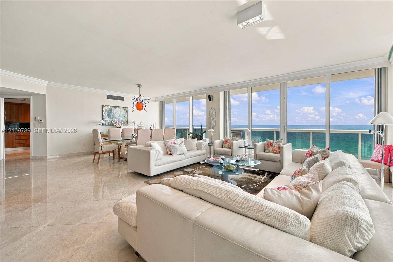 9595 Collins Avenue, #N6-B, Surfside, Surfside, FL 33154 Open-concept interior featuring large-format tile flooring, floor-to-ceiling glass wall panels, and an external balcony with ocean scenery