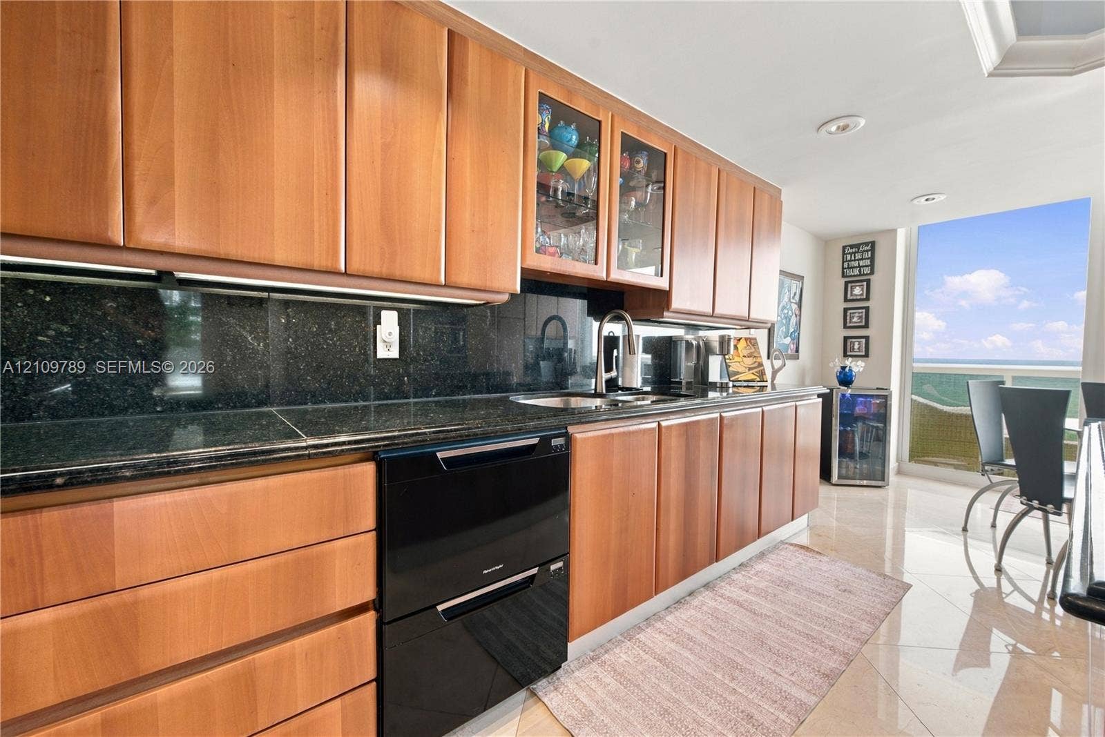 9595 Collins Avenue, #N6-B, Surfside, Surfside, FL 33154 Kitchen featuring flat-panel wood cabinetry, dark stone countertops, an integrated dishwasher, glass-front upper cabinet doors, and recessed lighting