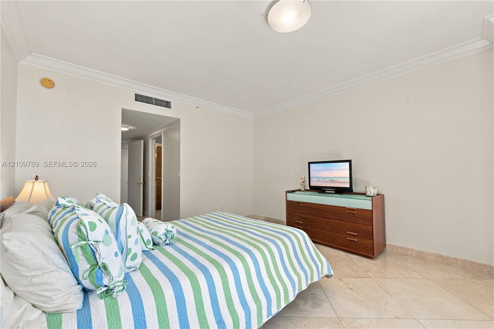 9595 Collins Avenue, #N6-B, Surfside, Surfside, FL 33154 Neutral-toned walls with crown molding, stone-finish tile flooring, and a flush-mount light fixture