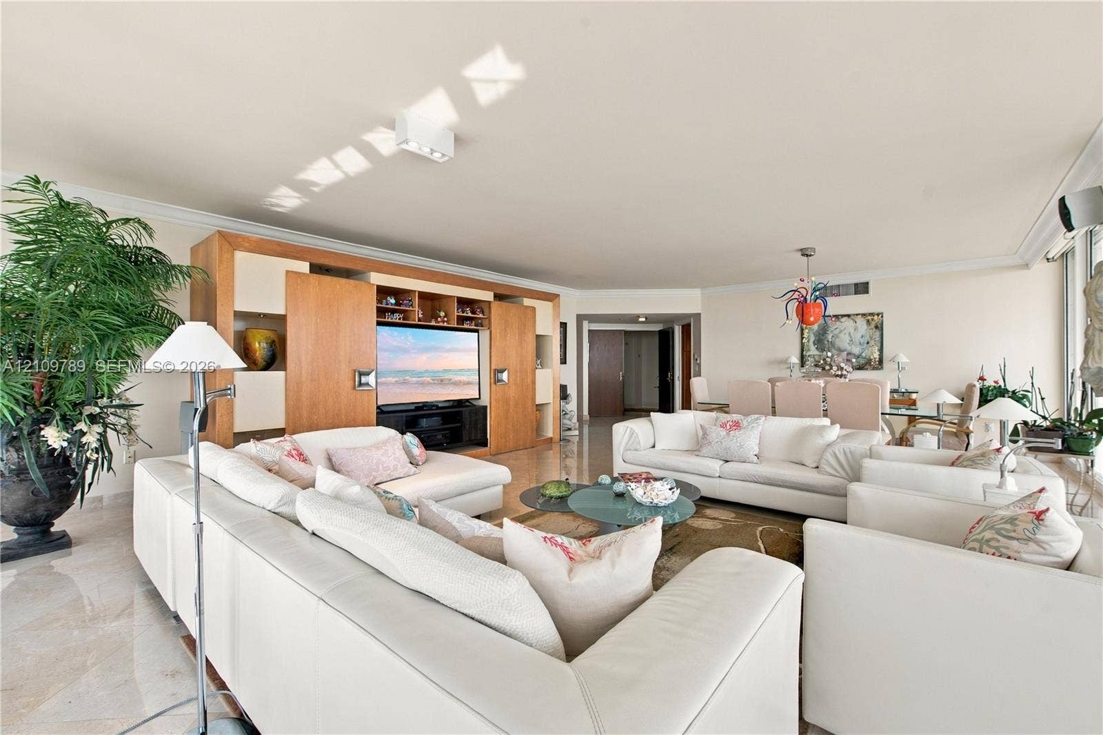 9595 Collins Avenue, #N6-B, Surfside, Surfside, FL 33154 Living area featuring polished stone flooring, custom built-in wood cabinetry, and recessed ceiling lighting