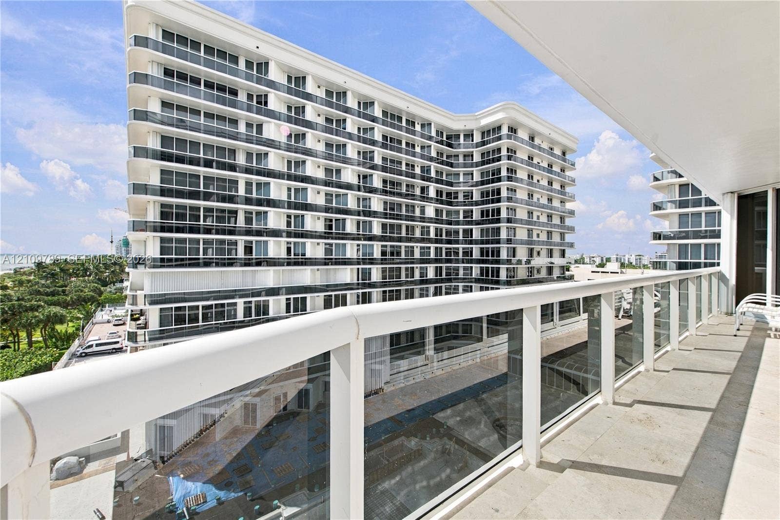 9595 Collins Avenue, #N6-B, Surfside, Surfside, FL 33154 Private balcony featuring a glass panel railing with a top white handrail and large-format stone flooring