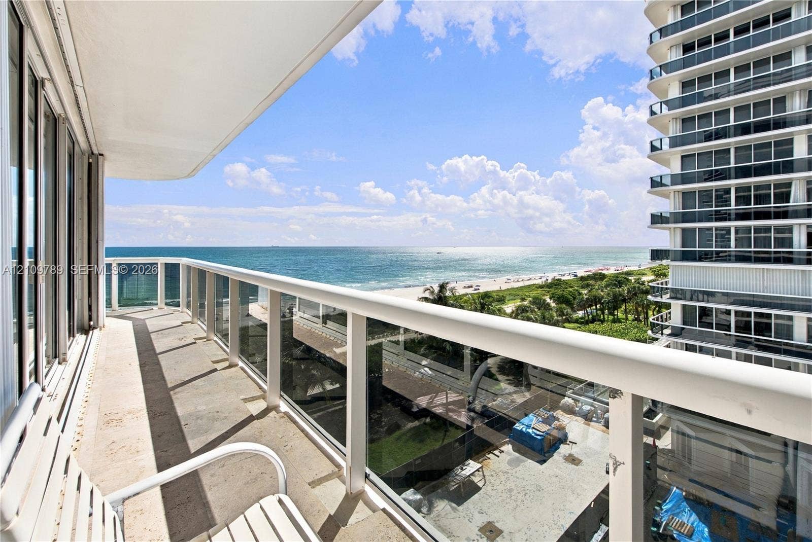 9595 Collins Avenue, #N6-B, Surfside, Surfside, FL 33154 Covered balcony featuring stone flooring and a white railing with glass panels