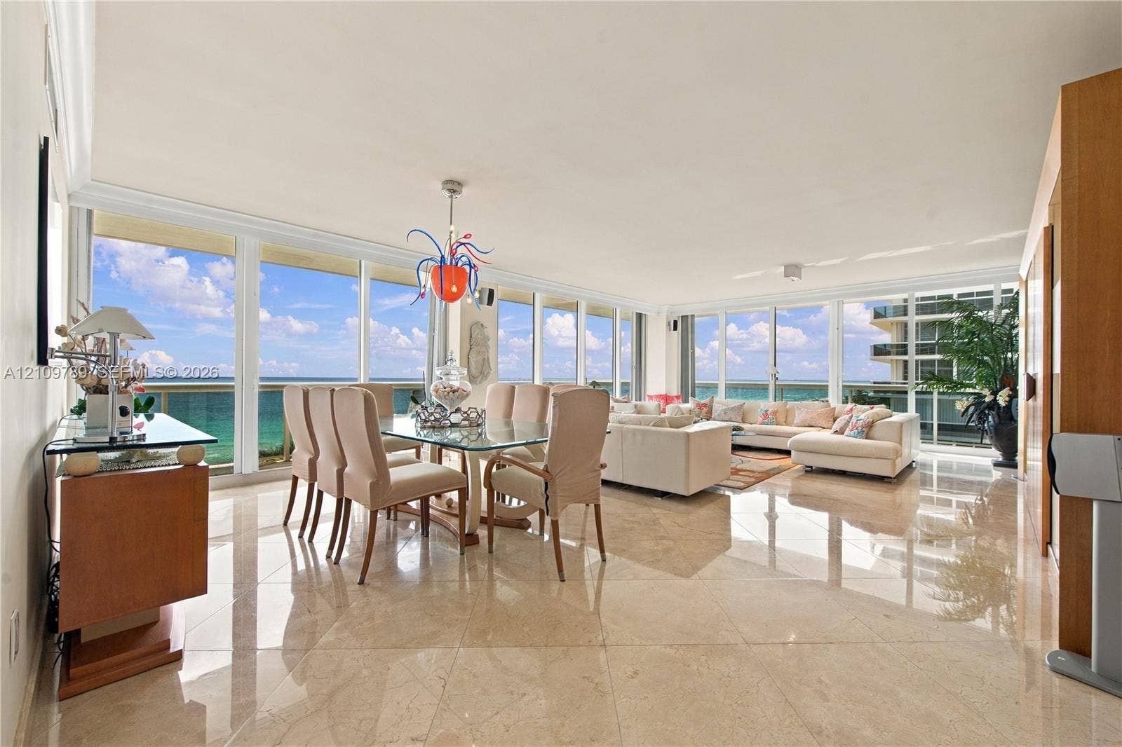 9595 Collins Avenue, #N6-B, Surfside, Surfside, FL 33154 Open-concept living space featuring floor-to-ceiling glass windows, polished stone flooring, and expansive ocean scenery