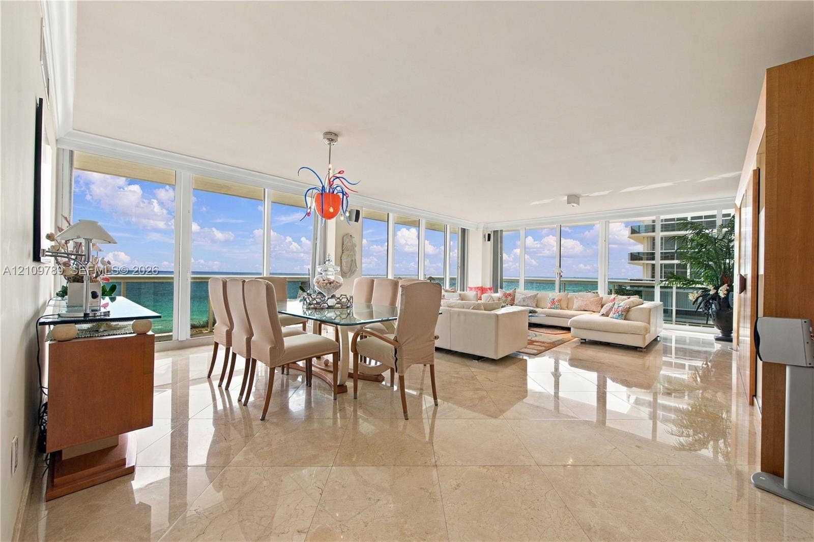 9595 Collins Avenue, #N6-B, Surfside, Surfside, FL 33154 Open-concept interior featuring floor-to-ceiling windows, polished stone flooring, and expansive glass sliding doors