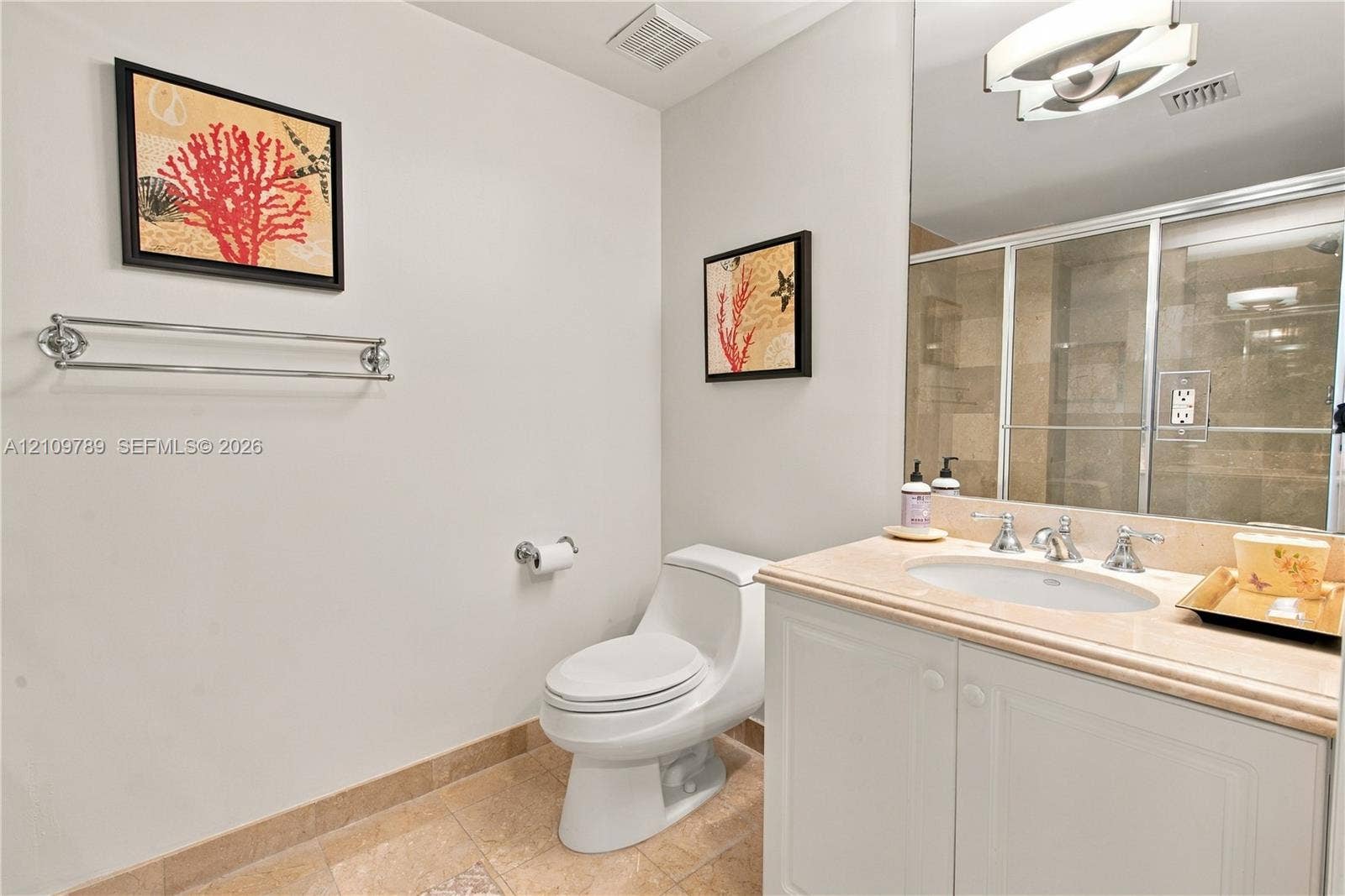 9595 Collins Avenue, #N6-B, Surfside, Surfside, FL 33154 Bathroom featuring a vanity with a stone-top integrated sink, a glass-enclosed shower, wall-to-wall mirror, polished chrome hardware, and tile flooring