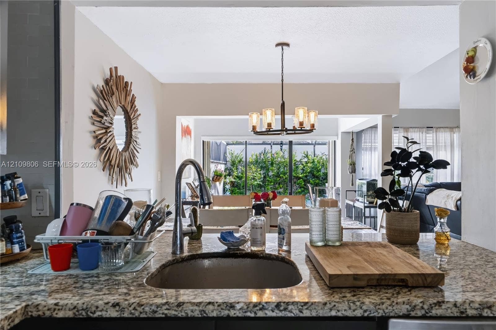 9123 SW 117th Court, Miami, FL 33186 Kitchen featuring stone countertops, an undermount sink with a gooseneck faucet, and a multi-arm pendant light fixture