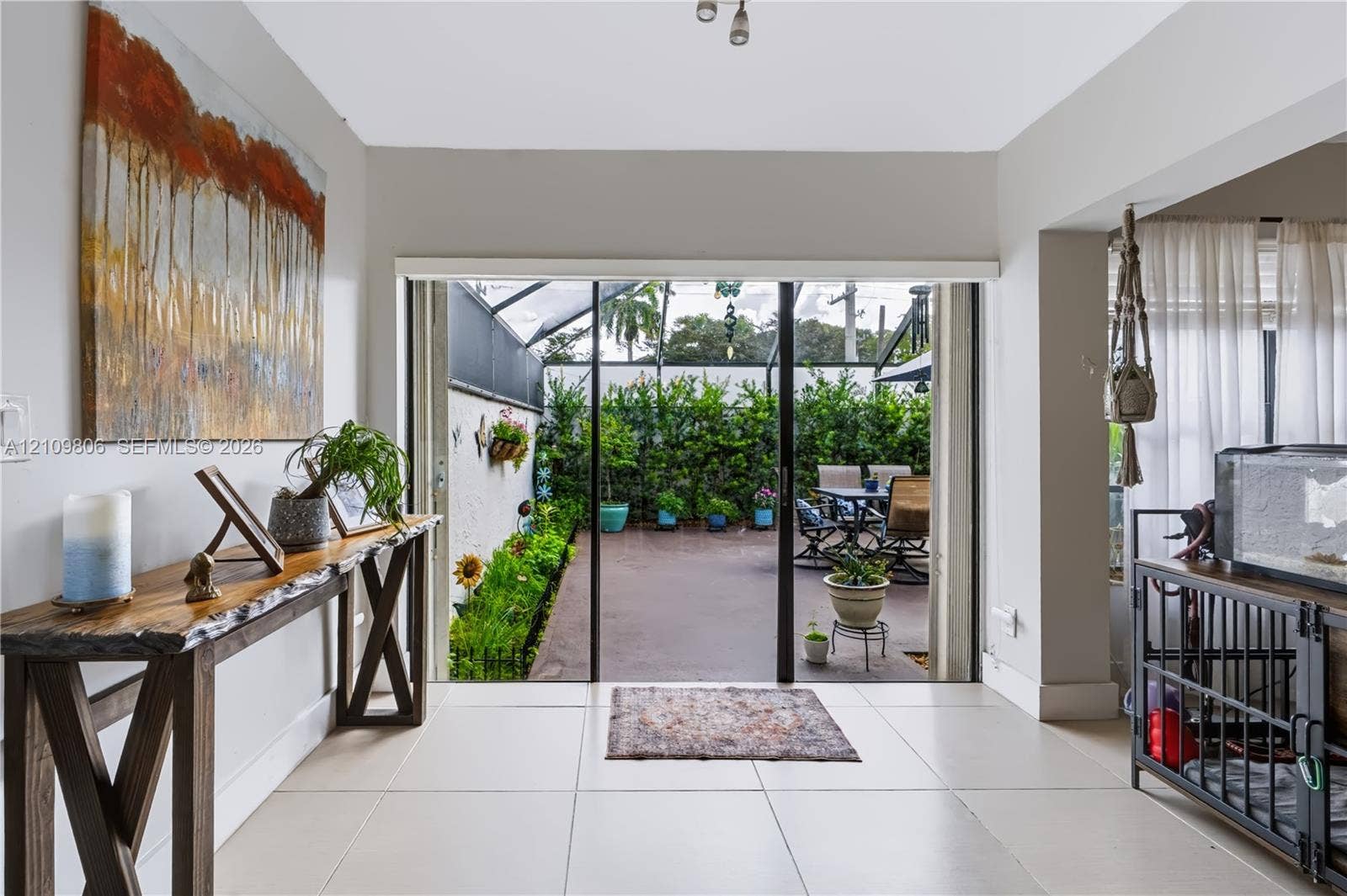 9123 SW 117th Court, Miami, FL 33186 Interior featuring large-format tile flooring and sliding glass doors opening to a screened patio