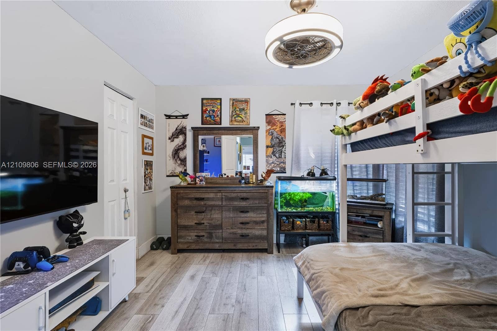 9123 SW 117th Court, Miami, FL 33186 Wood-finish flooring, neutral wall tones, and a modern circular ceiling light fixture