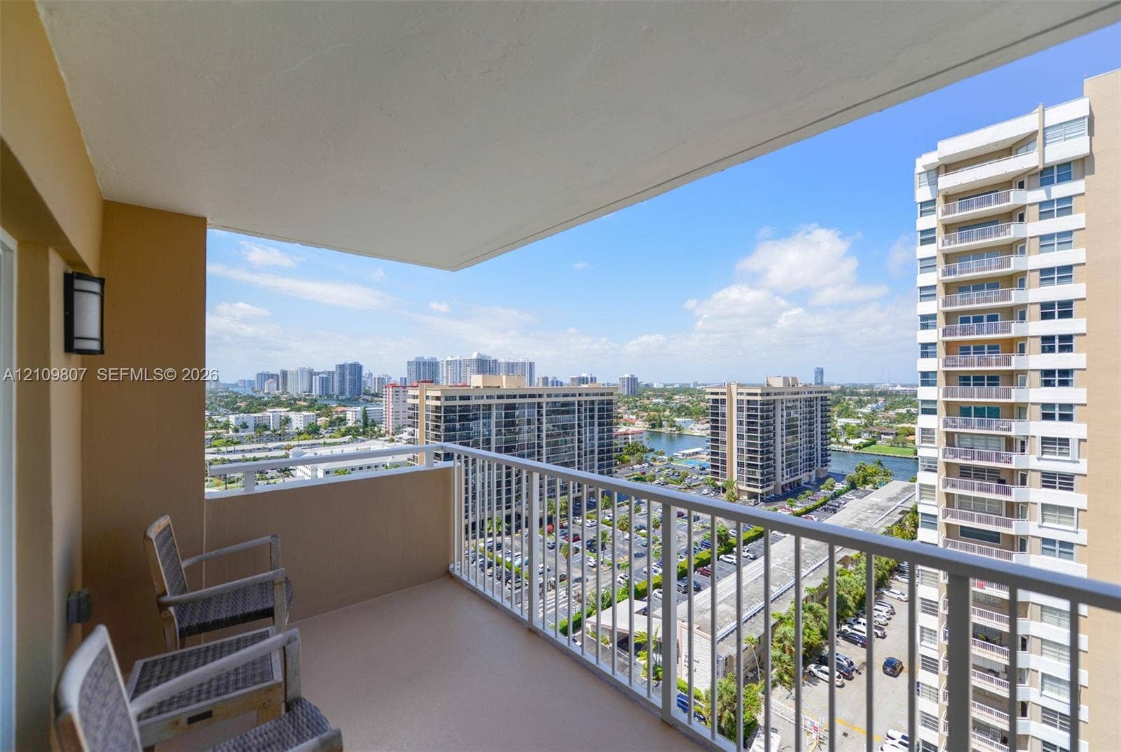 1980 S Ocean Drive, #16Q, Hallandale Beach, FL 33009 Covered balcony featuring white metal railings and wall-mounted exterior lighting