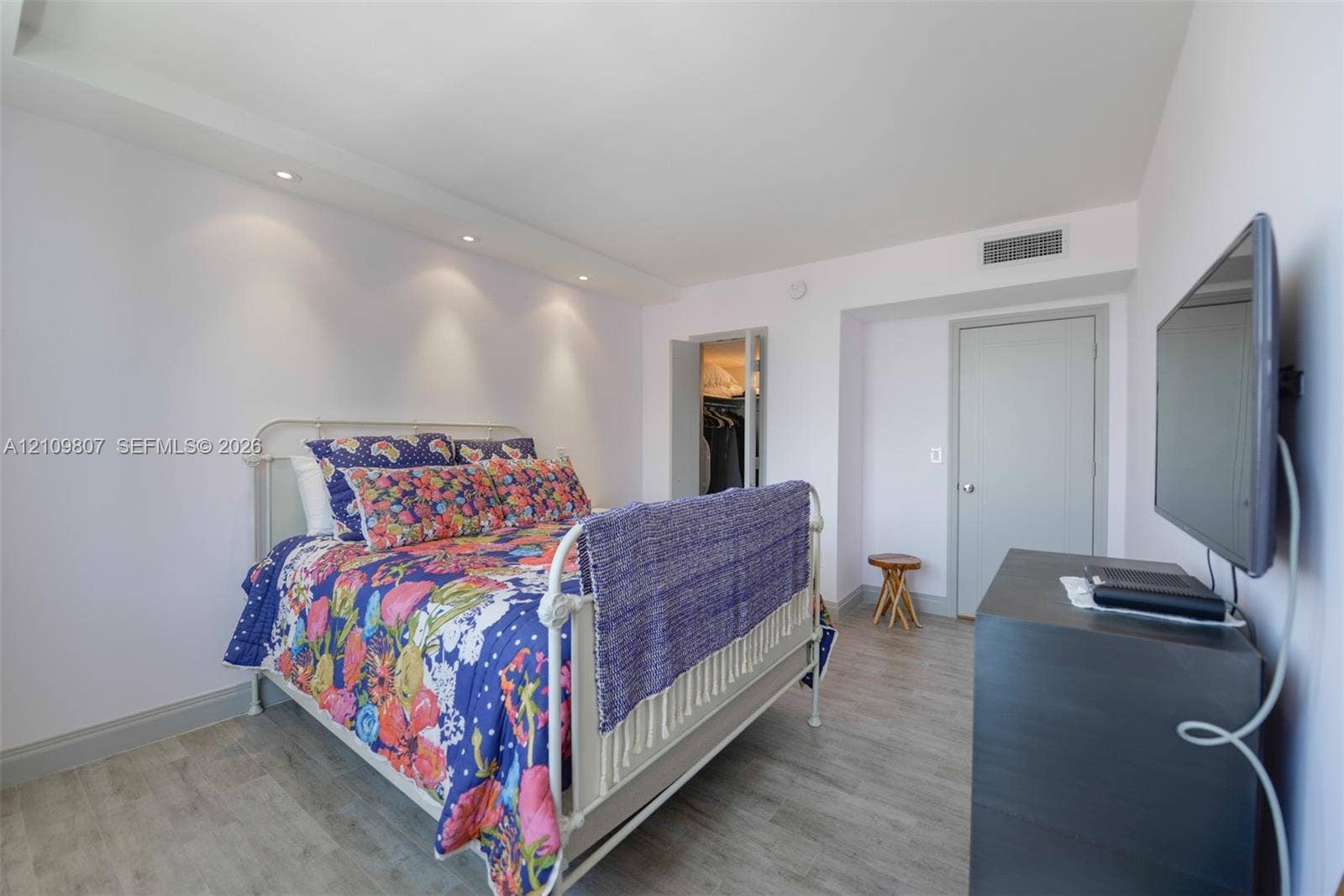 1980 S Ocean Drive, #16Q, Hallandale Beach, FL 33009 Interior space featuring wood-finish flooring, recessed ceiling lighting, and a reach-in closet with double doors