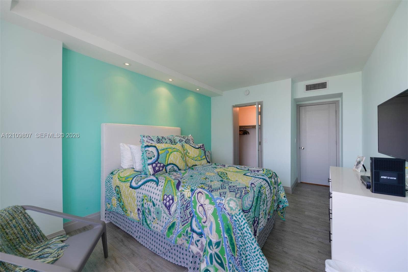 1980 S Ocean Drive, #16Q, Hallandale Beach, FL 33009 Bedroom featuring wood-finish flooring, recessed lighting, and a walk-in closet with built-in shelving