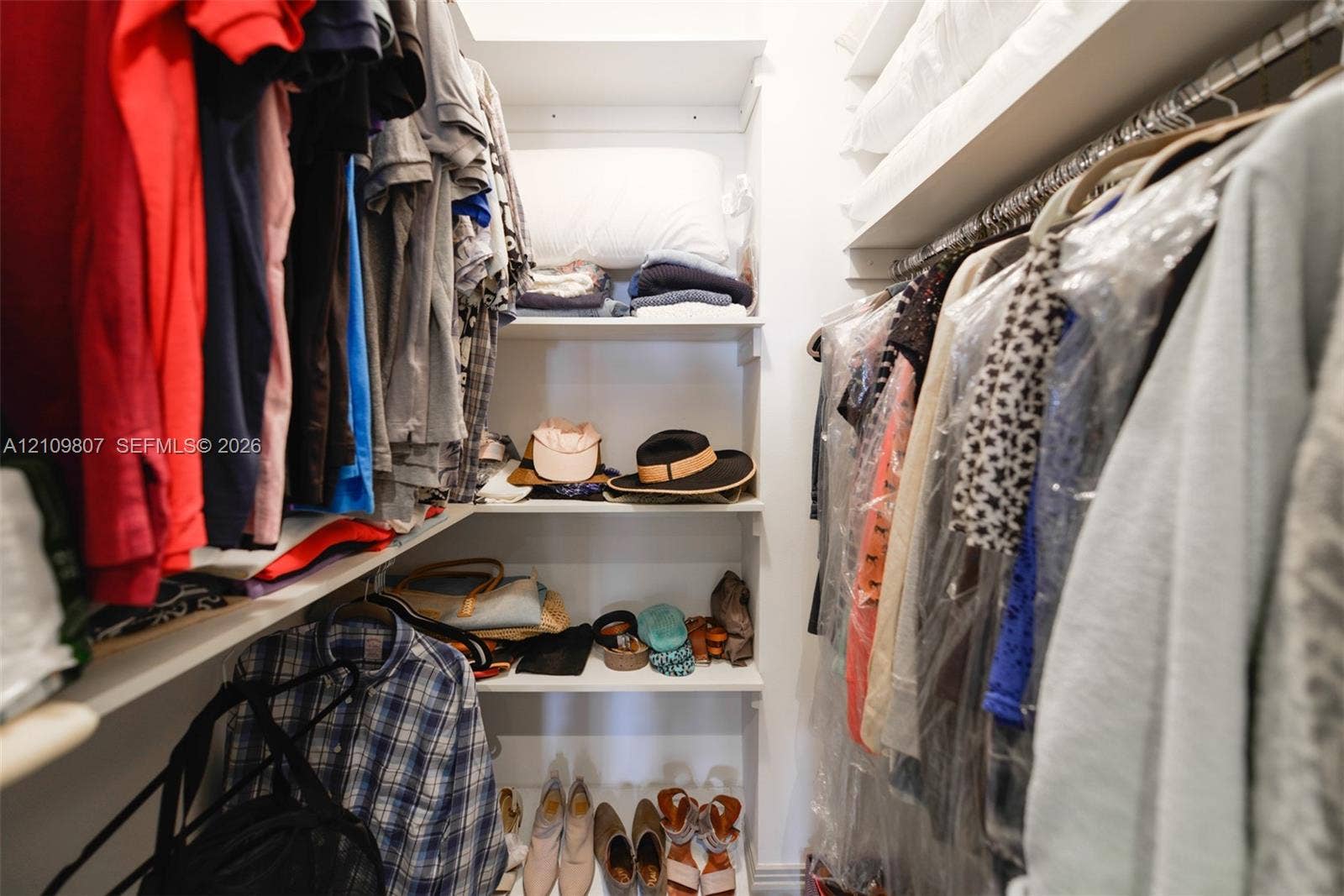 1980 S Ocean Drive, #16Q, Hallandale Beach, FL 33009 Walk-in closet featuring built-in shelving and dual-level hanging rods
