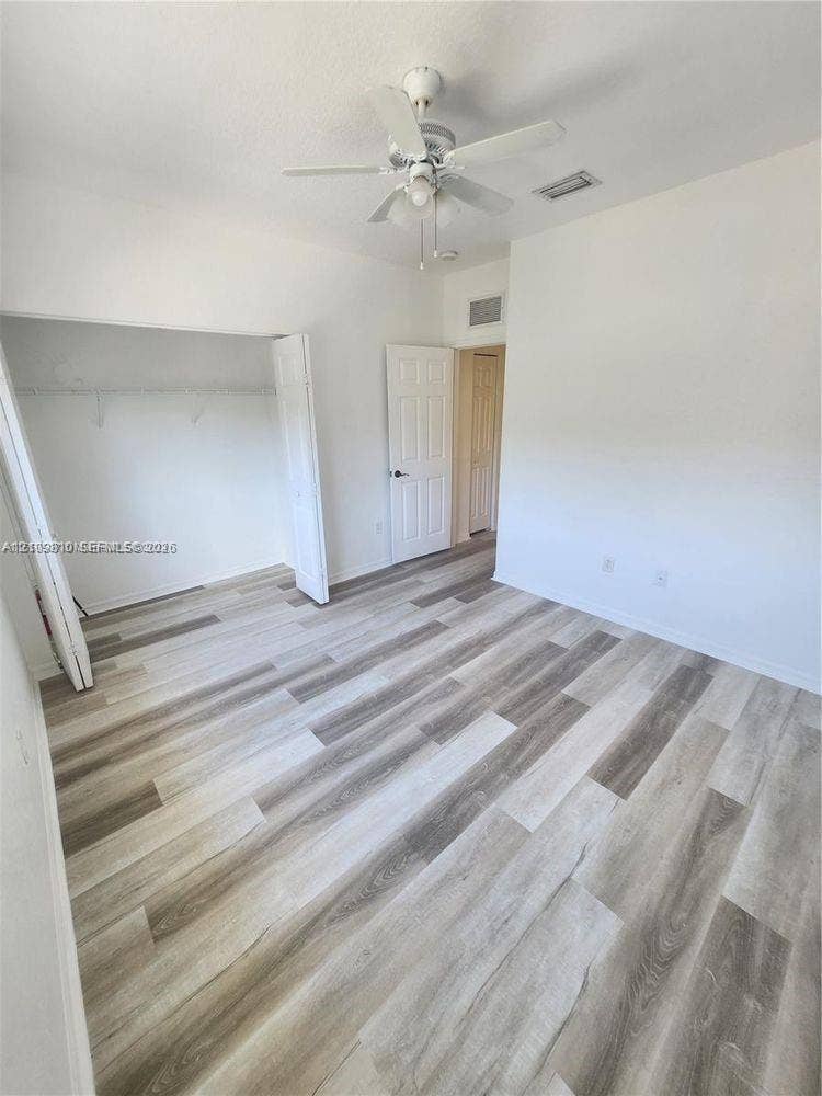 Wood-finish flooring, ceiling fan, and multi-panel interior doors