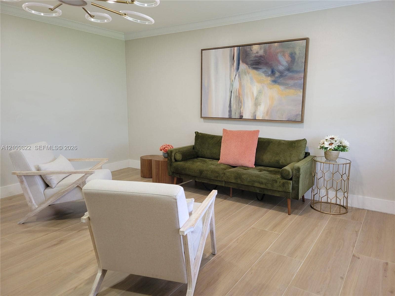 913 Lighthouse Drive, North Palm Beach, North Palm Beach, FL 33408 Light-toned wood-finish flooring, neutral wall palette, crown molding, and a contemporary multi-ring flush-mount ceiling fixture