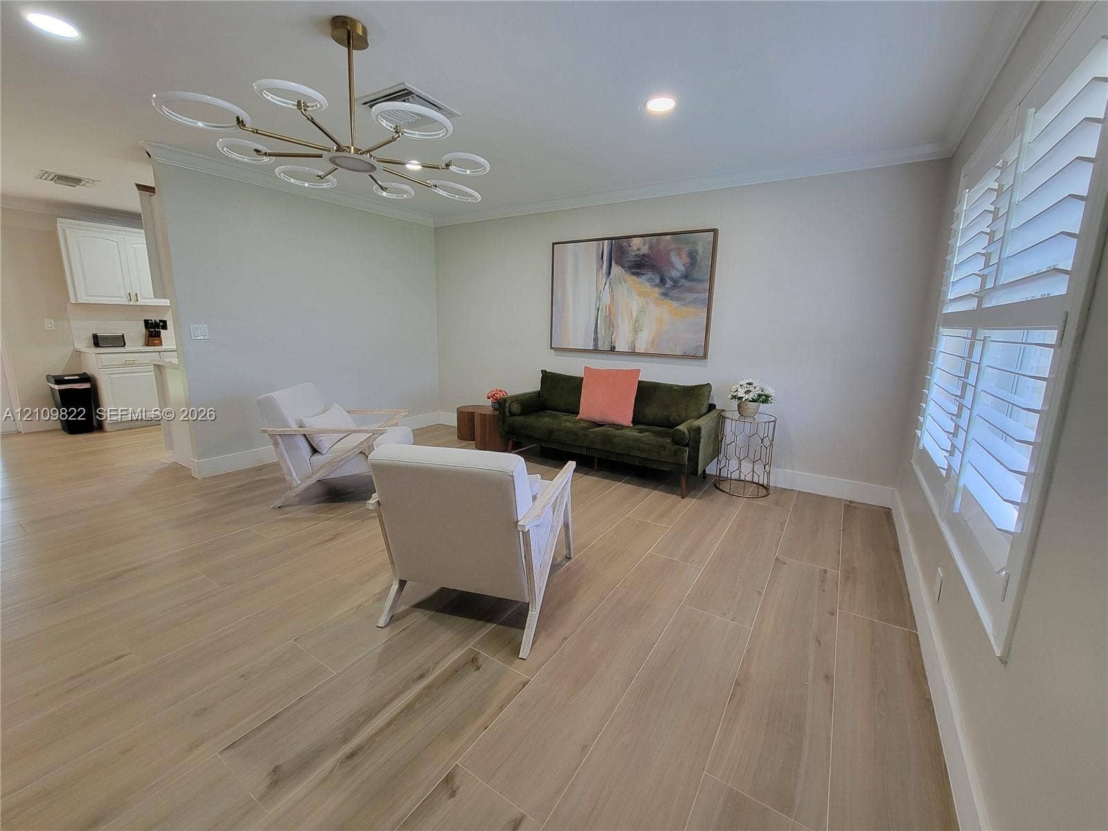 913 Lighthouse Drive, North Palm Beach, North Palm Beach, FL 33408 Wood-finish flooring, contemporary multi-ring chandelier, recessed lighting, and white plantation shutters