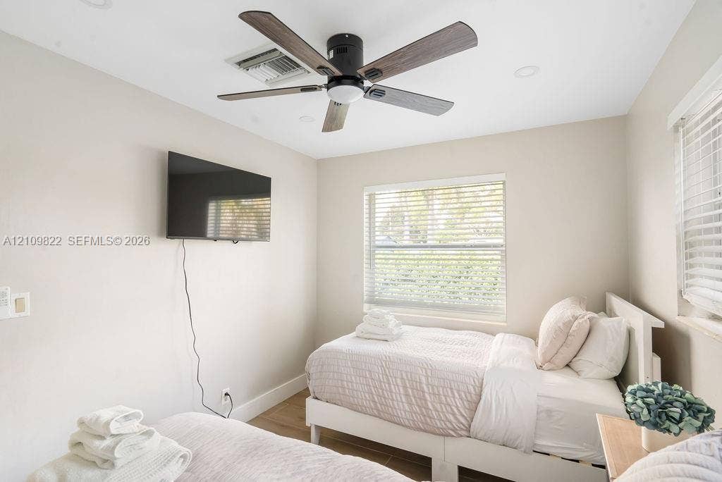 913 Lighthouse Drive, North Palm Beach, North Palm Beach, FL 33408 Neutral-toned interior featuring recessed lighting, a modern ceiling fan with wood-finish blades, and windows equipped with horizontal blinds