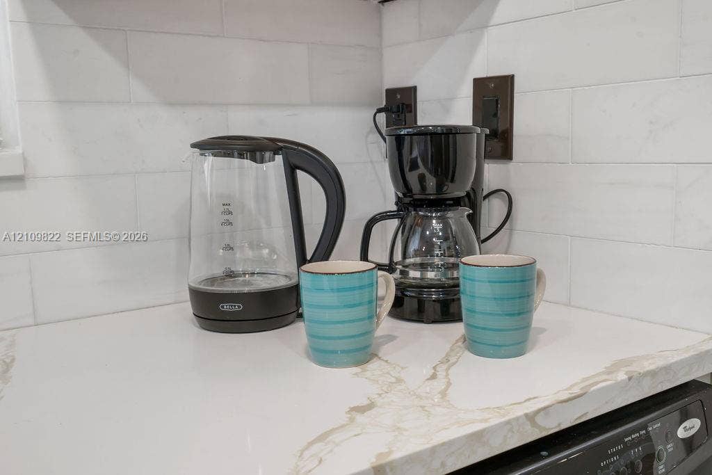 913 Lighthouse Drive, North Palm Beach, North Palm Beach, FL 33408 Quartz countertop featuring veined detailing and a white subway tile backsplash