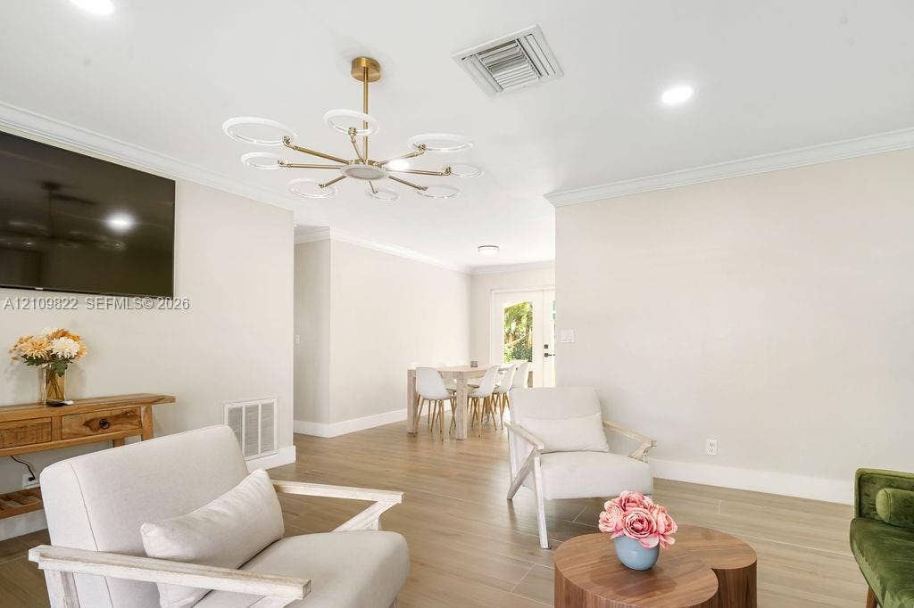 913 Lighthouse Drive, North Palm Beach, North Palm Beach, FL 33408 Modern multi-arm ring chandelier, recessed lighting, crown molding, and continuous wood-finish flooring