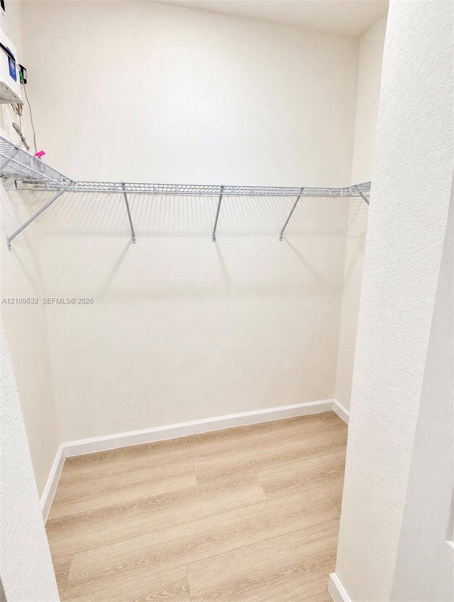 8800 NW 97th Avenue, #205, Doral, FL 33178 Storage space featuring wood-finish flooring and wall-mounted wire shelving