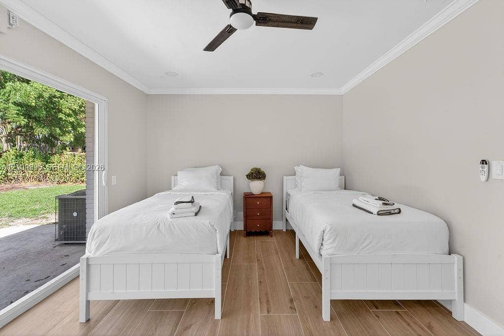 756 Cinnamon Road, North Palm Beach, North Palm Beach, FL 33408 Room featuring wood-finish tile flooring, a neutral color palette, recessed lighting, a modern ceiling fan, and a large sliding glass door