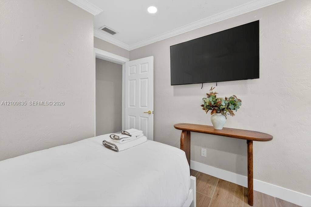 756 Cinnamon Road, North Palm Beach, North Palm Beach, FL 33408 Neutral wall tones, wood-finish tile flooring, crown molding, and recessed lighting