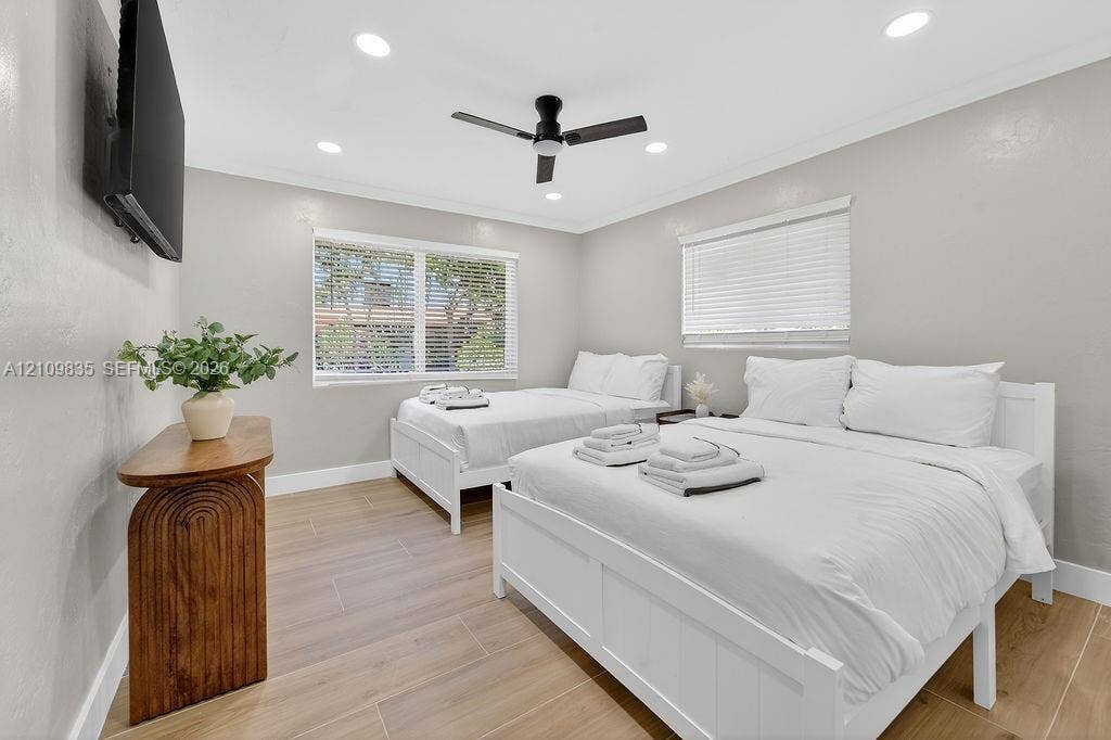 756 Cinnamon Road, North Palm Beach, North Palm Beach, FL 33408 Wood-finish flooring, recessed lighting, matte black ceiling fan, and dual windows with fitted blinds