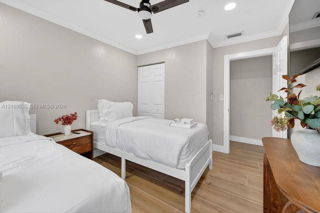 756 Cinnamon Road, North Palm Beach, North Palm Beach, FL 33408 Wood-finish flooring, crown molding, ceiling fan with integrated lighting, recessed lighting, and double-door closet