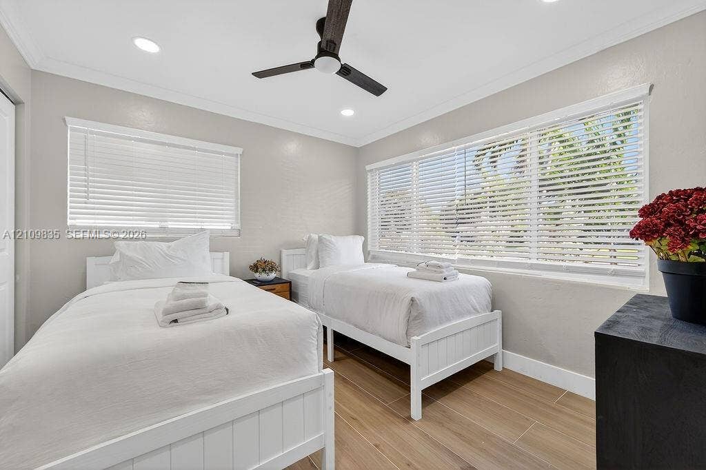 756 Cinnamon Road, North Palm Beach, North Palm Beach, FL 33408 Neutral-toned room featuring wood-finish flooring, recessed lighting, a modern ceiling fan, and large windows with horizontal blinds