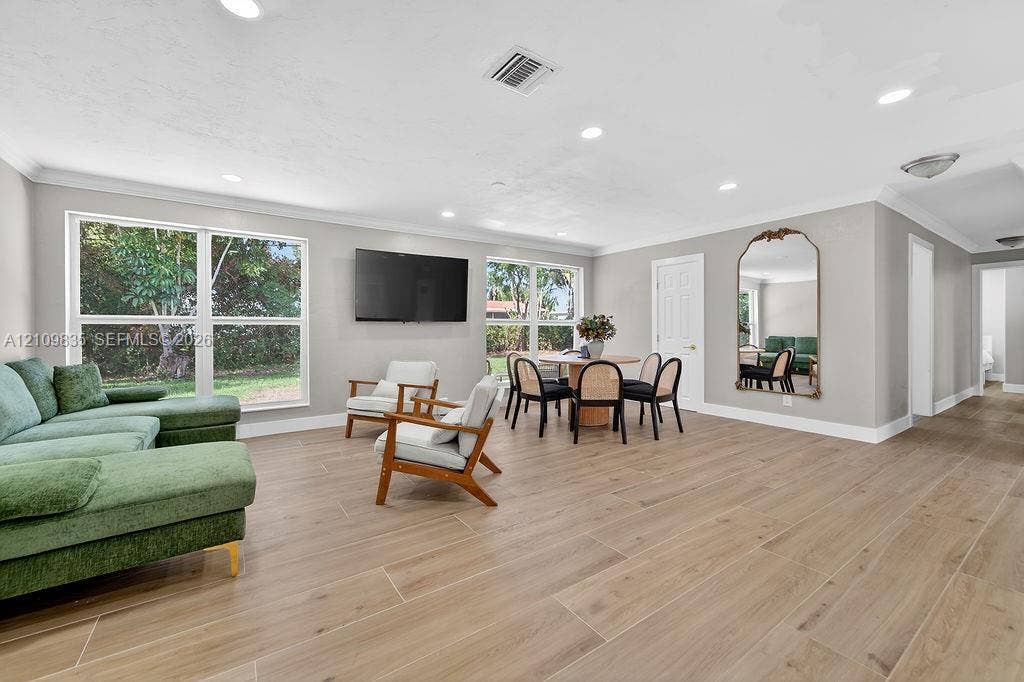 756 Cinnamon Road, North Palm Beach, North Palm Beach, FL 33408 Open-concept interior featuring wood-finish tile flooring, recessed lighting, and large windows providing natural light