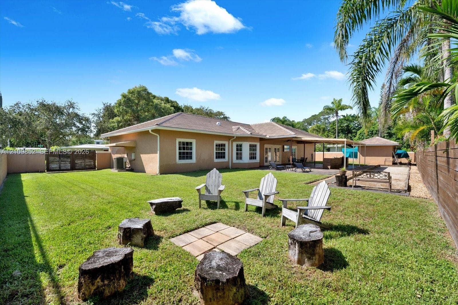 7901 SW 97th Street, Miami, FL 33156 Expansive & private backyard featuring a manicured lawn and the dedicated space for entertaining with a fire pit * Owners paid extra to have the utility lines buried underground *