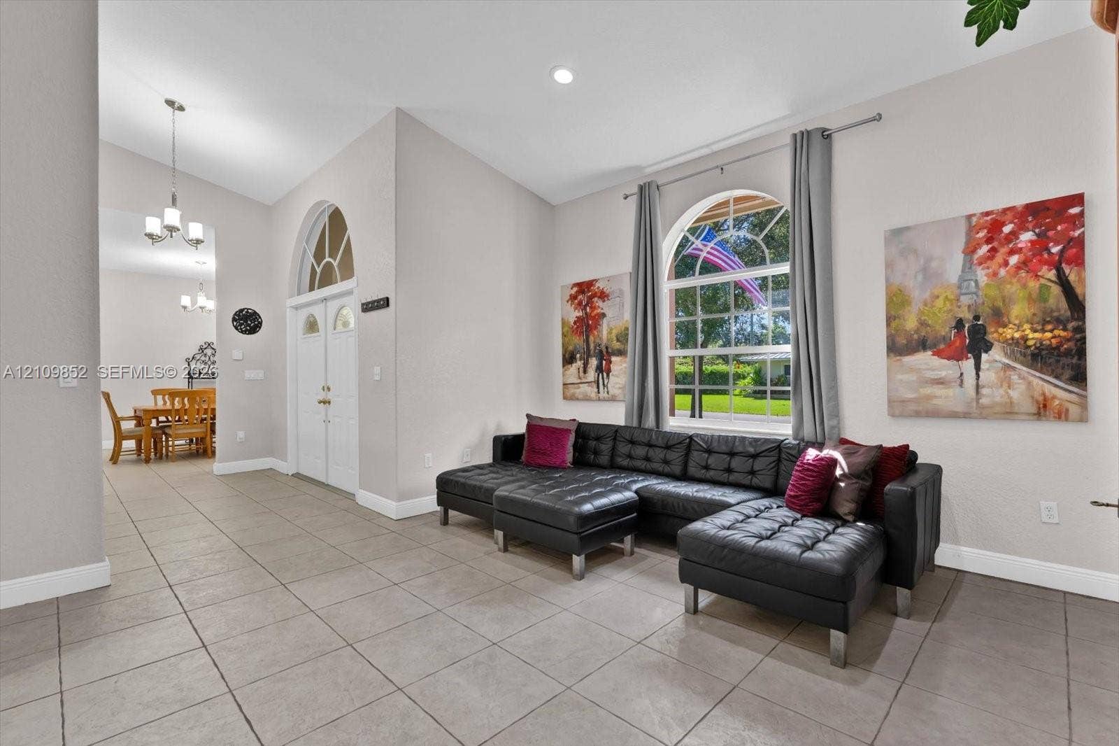 7901 SW 97th Street, Miami, FL 33156 View of the formal living room and double door at the front foyer * natural lighting coiming in from the large arched windows, even above the front door.