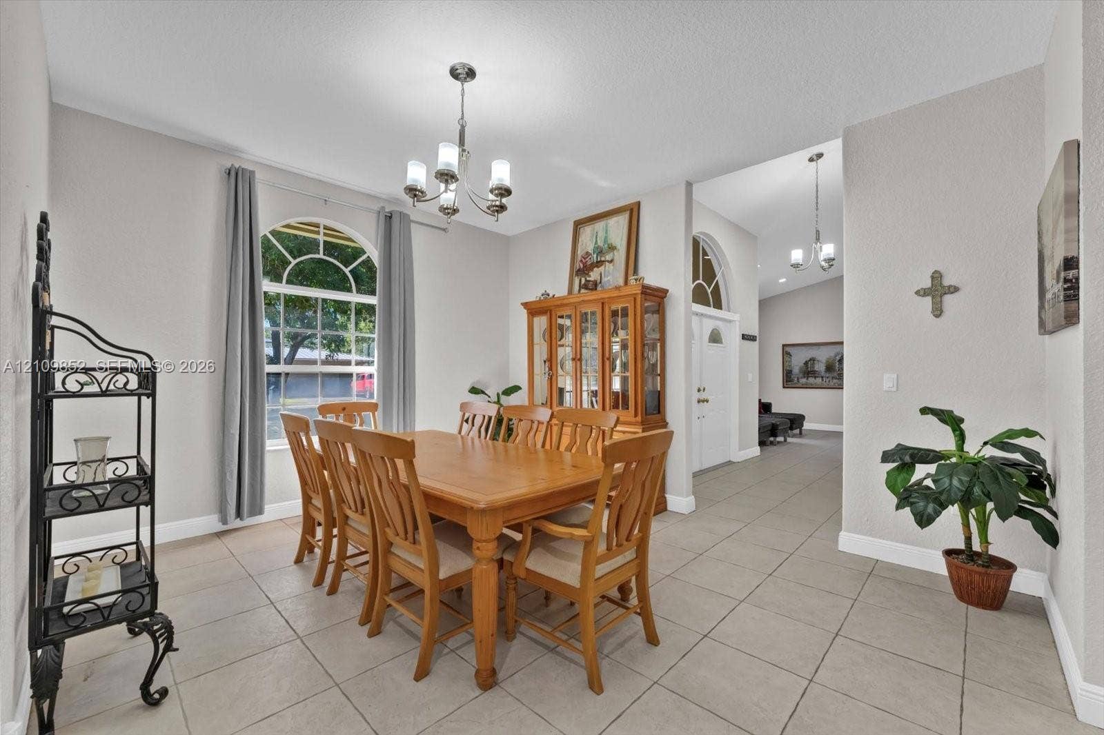 7901 SW 97th Street, Miami, FL 33156 Formal dining area with an arched window allowing for natural lighting to enter this space *