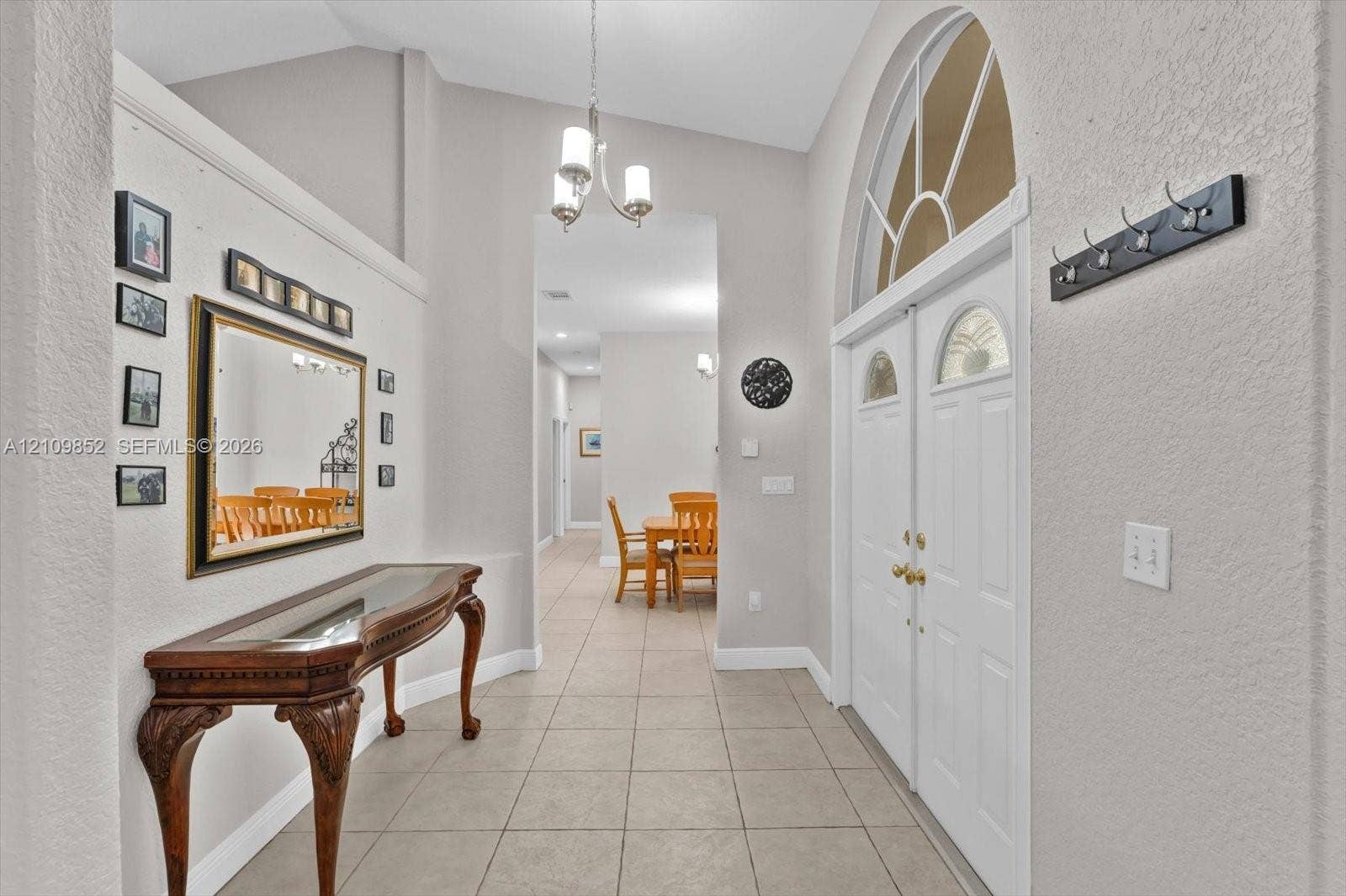7901 SW 97th Street, Miami, FL 33156 Formal foyer featuring volume ceilings, tile flooring, and a double-door entry with an arched transom window *