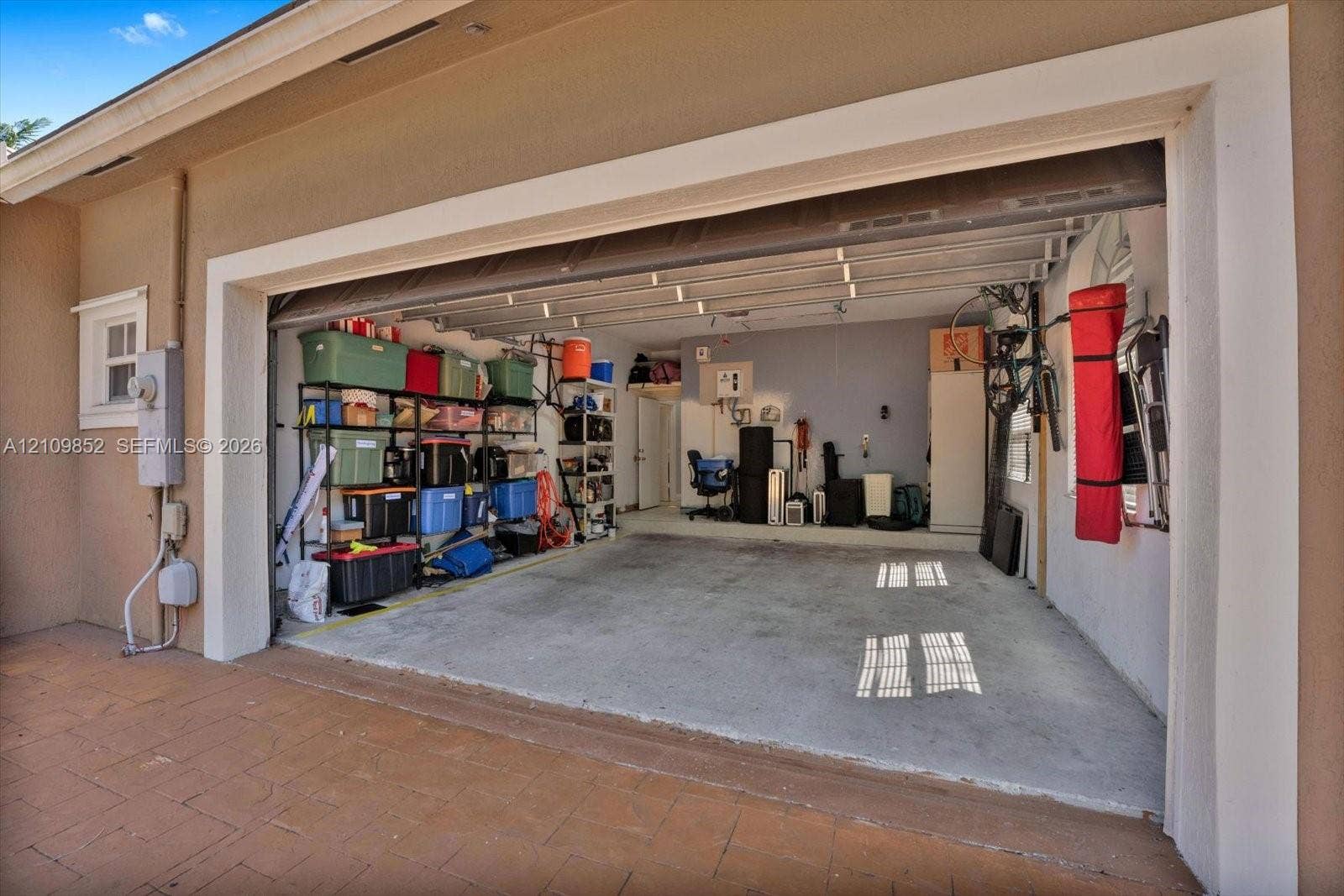 7901 SW 97th Street, Miami, FL 33156 Two-car capacity garage featuring a concrete floor, finished interior walls, tankless water heater and capacity to charge your car *