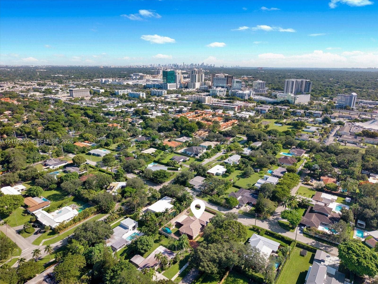 7901 SW 97th Street, Miami, FL 33156 Aerial perspective showcasing this residential property situated within a mature landscape featuring extensive tree canopy and proximity to urban skyline of Downtown Dadeland *