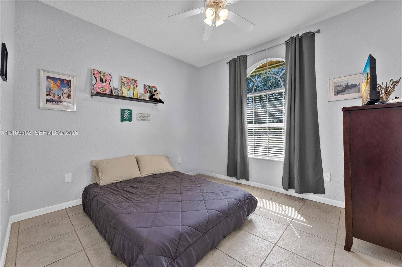 7901 SW 97th Street, Miami, FL 33156 Southern facing bedroom with high celings and neutral-toned tile flooring and arched window *