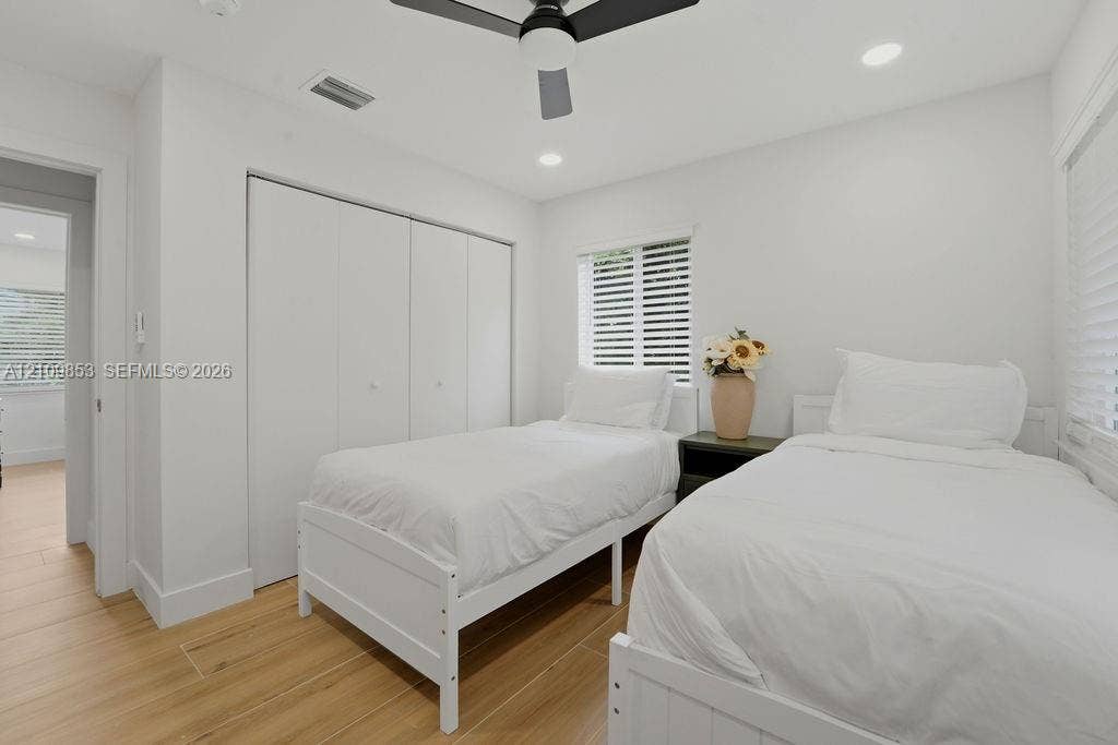 800 Alamanda Drive, North Palm Beach, North Palm Beach, FL 33408 Room featuring wood-finish flooring, recessed lighting, a modern ceiling fan, and built-in closet storage
