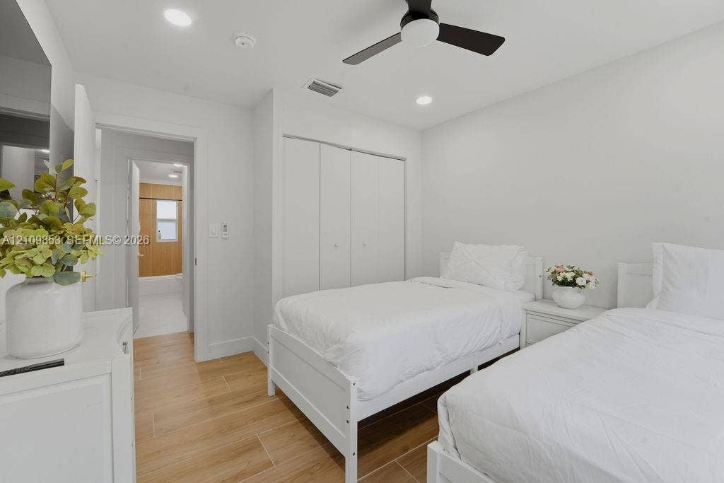 800 Alamanda Drive, North Palm Beach, North Palm Beach, FL 33408 Wood-finish flooring, recessed lighting, matte black ceiling fan, and built-in closet with double-panel doors