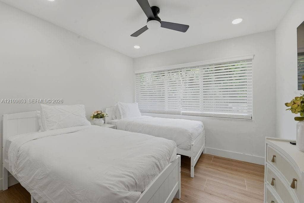 800 Alamanda Drive, North Palm Beach, North Palm Beach, FL 33408 Wood-finish flooring, recessed lighting, matte black ceiling fan, and large windows with horizontal blinds