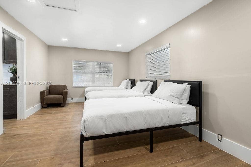 736 Prosperity Farms Road, North Palm Beach, North Palm Beach, FL 33408 Neutral-toned interior featuring wood-finish flooring, recessed lighting, and horizontal window blinds