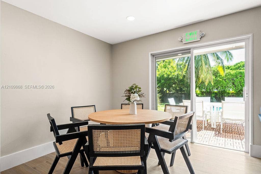 736 Prosperity Farms Road, North Palm Beach, North Palm Beach, FL 33408 Neutral-toned interior space featuring wood-finish flooring, recessed lighting, and a sliding glass door providing outdoor exposure