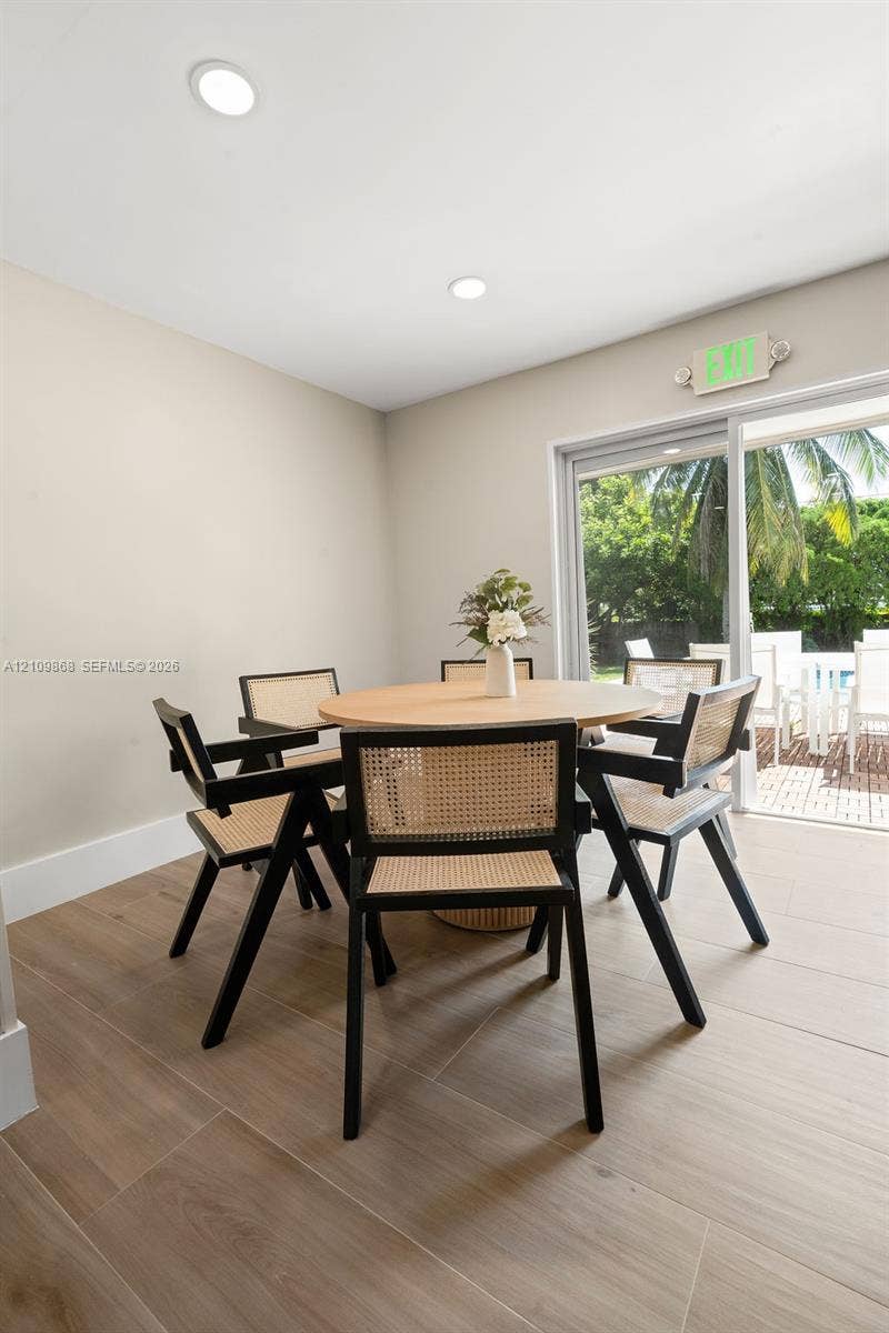 736 Prosperity Farms Road, North Palm Beach, North Palm Beach, FL 33408 Neutral-toned interior space featuring wood-finish flooring, recessed lighting, and a sliding glass door