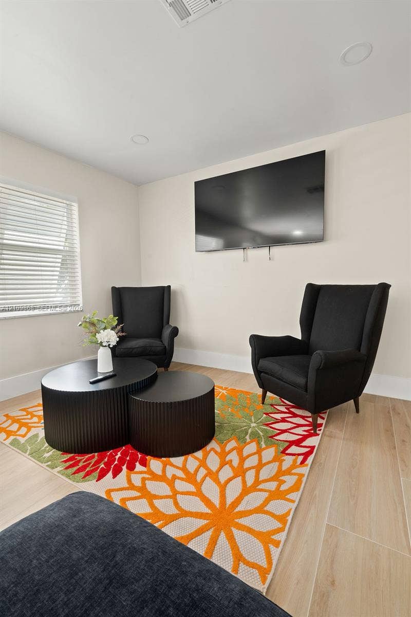 736 Prosperity Farms Road, North Palm Beach, North Palm Beach, FL 33408 Room featuring wood-finish flooring, neutral wall paint, recessed lighting, and horizontal window blinds