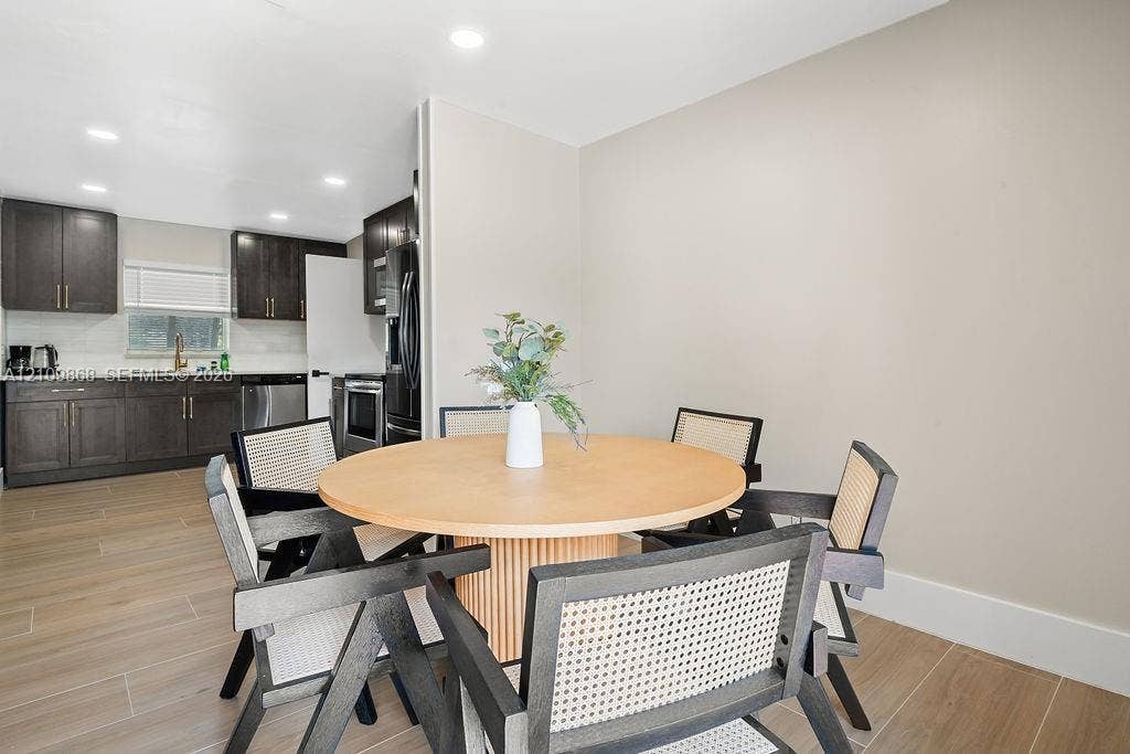 736 Prosperity Farms Road, North Palm Beach, North Palm Beach, FL 33408 Kitchen featuring dark-toned shaker cabinetry, recessed lighting, wood-finish flooring, and stainless steel appliances