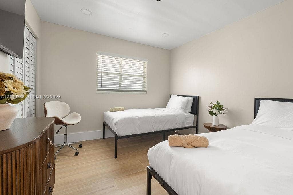 736 Prosperity Farms Road, North Palm Beach, North Palm Beach, FL 33408 Neutral-toned interior featuring wood-finish flooring, recessed lighting, and white plantation-style shutters