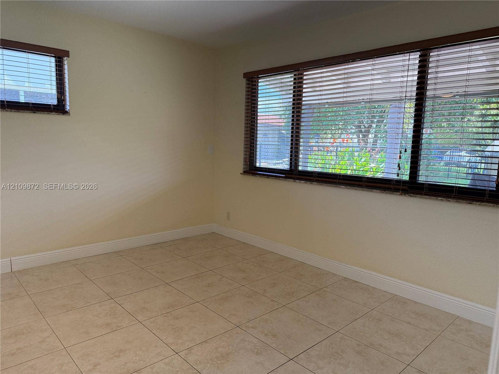 811 NE 10th Street, #5, Hallandale Beach, Hallandale Beach, FL 33009 Room featuring neutral wall finishes, tile flooring, and windows with horizontal blinds