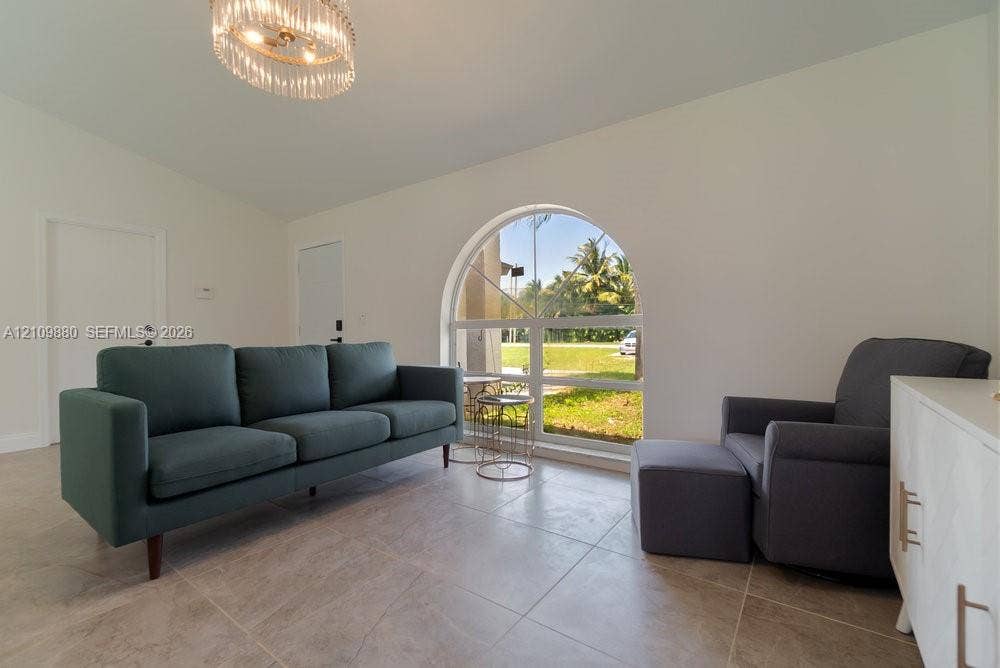 8231 Coconut Boulevard, West Palm Beach, West Palm Beach, FL 33412 Vaulted ceilings, oversized arched window, large-format tile flooring, and a crystal tiered chandelier