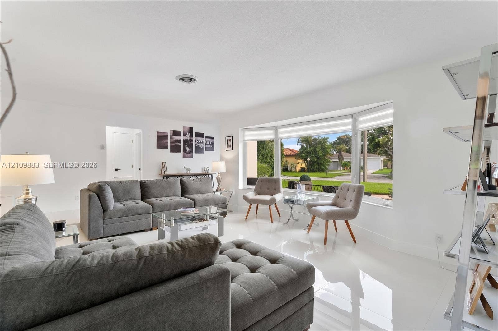 751 SW 54th Avenue, Margate, FL 33068 Living area featuring polished tile flooring, expansive bay window, and crisp white wall finishes